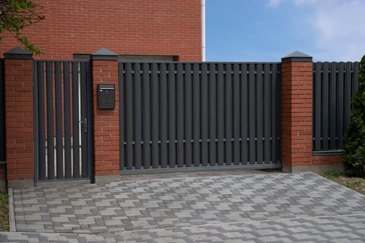Modern dark metal driveway gate